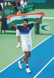 Rohan Bopanna on the tennis court at the Australian Open 2024, showcasing his winning skills and ecstatic victory celebration.