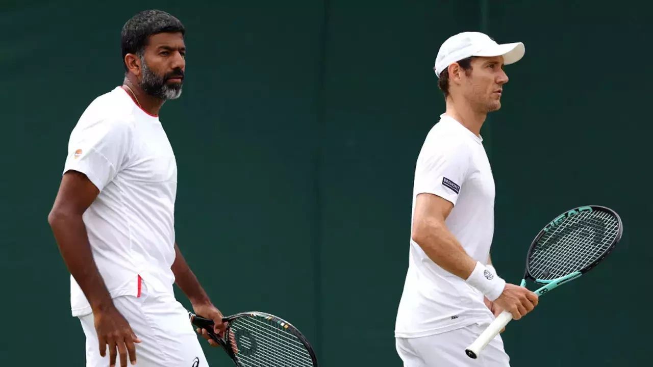 Rohan Bopanna raising his arms in victory at the Australian Open 2024, embodying the spirit of triumph in tennis.